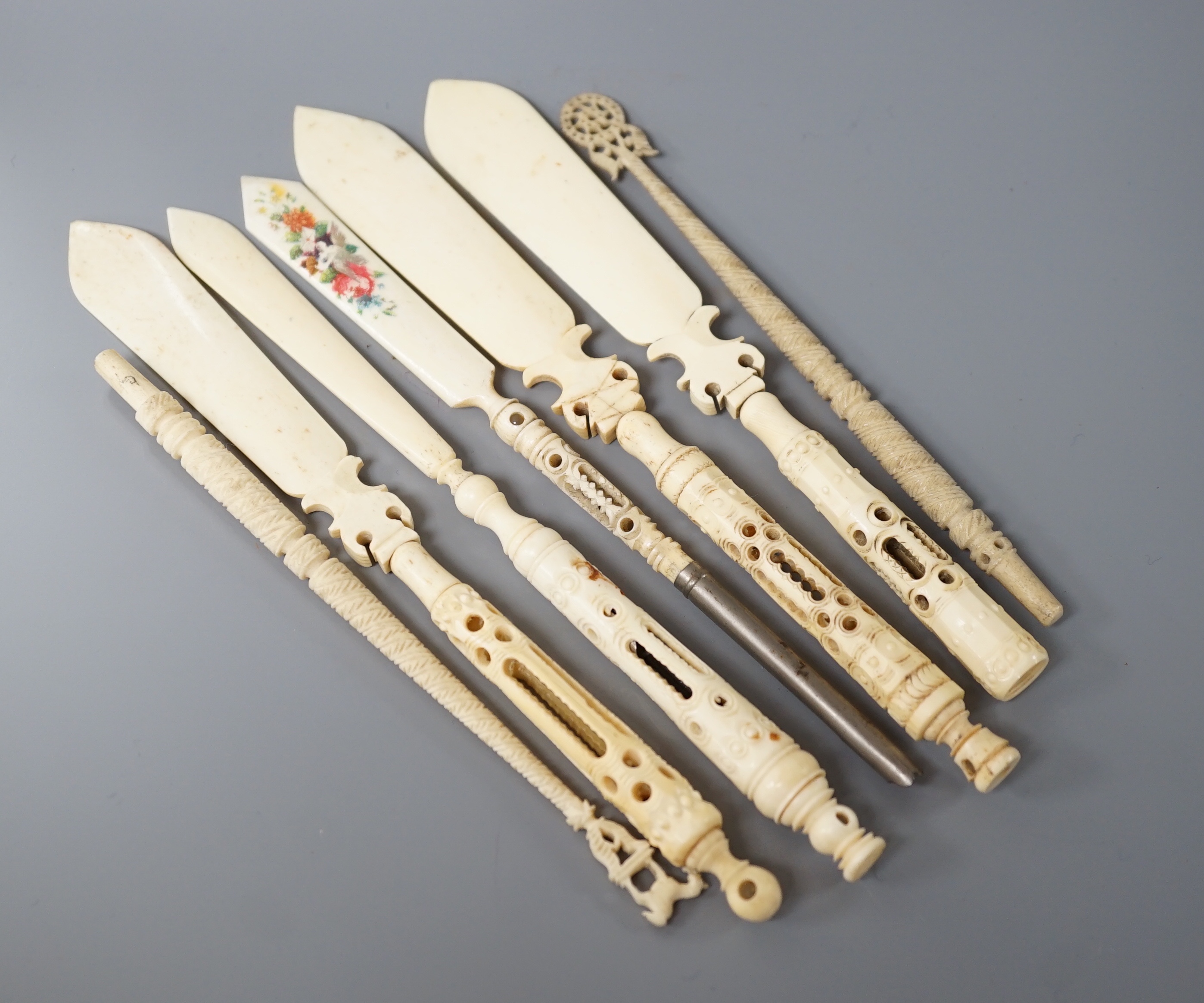 Four Victorian bone Stanhope paper knives, and three other bone items